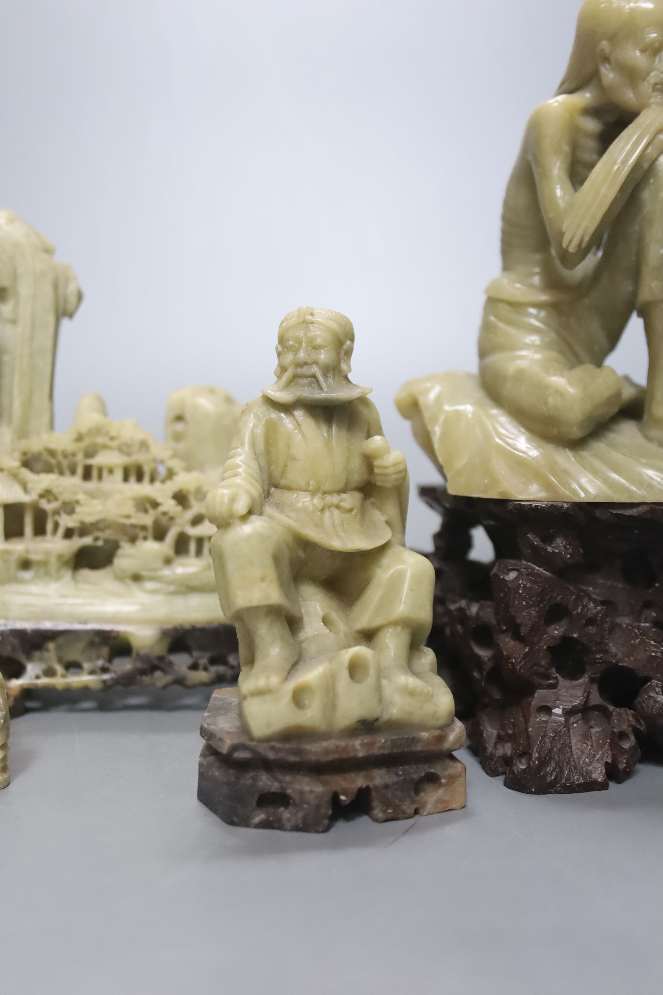 Seven Chinese soapstone carvings, 4 figurative carvings, largest 26 cms high including base.